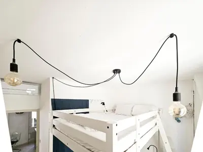 a bedroom with a white bed and two lights at Fontaine 4 Pers AC WiFi in Nice