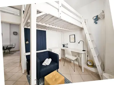 a room with a desk and a loft bed at Fontaine 4 Pers AC WiFi in Nice