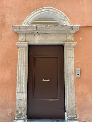 a building with a brown door with an arch above it at New- Cozy apartment -4 guests - Air conditioning in Nice