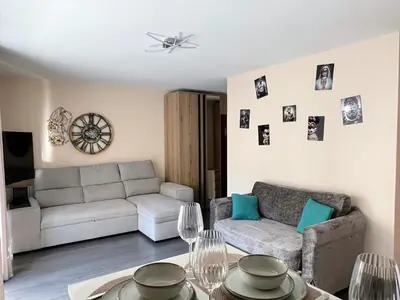a living room with a couch and a table at Studio élégant avec balcon près de la plage à Nice in Nice