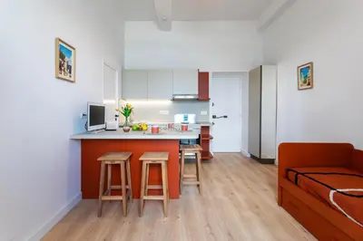 a kitchen and living room with a couch and a table at TERRACOTTA AP4457 By Riviera Holiday Homes in Villefranche-sur-Mer