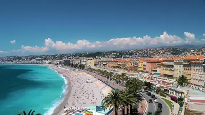 a view of a beach with people and the ocean at Nestor&Jeeves - PALAIS LASCARIS - Port in Nice