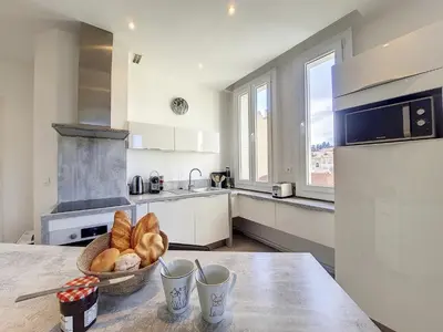 a kitchen with a table with a bowl of bread at Nestor&Jeeves - PALAIS LASCARIS - Port in Nice