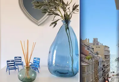 a blue vase sitting on a table with a mirror at Nestor&Jeeves - CHAISE BLEUE - Central - Near Beach in Nice