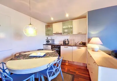 a kitchen with a table and a small kitchen with a dining room at Nestor&Jeeves - CHAISE BLEUE - Central - Near Beach in Nice