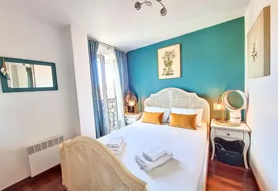 a bedroom with a white bed and a blue wall at Nestor&Jeeves - CHAISE BLEUE - Central - Near Beach in Nice