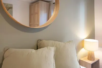 a mirror above a bed with a pillow and a lamp at #41 Flat for 6, 3 Bdrs Parking Wifi 5mins walk Tram T1 in Nice