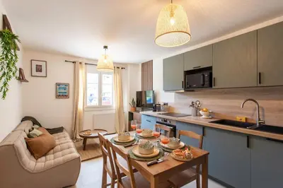 a kitchen and a living room with a table at #41 Flat for 6, 3 Bdrs Parking Wifi 5mins walk Tram T1 in Nice