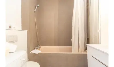 a bathroom with a shower with a tub and a toilet at Studio Nice clim wifi in Nice