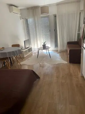 a living room with a table and a couch at Studio Nice clim wifi in Nice