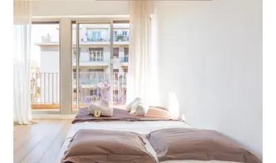 a bed in a room with a large window at Studio Nice clim wifi in Nice