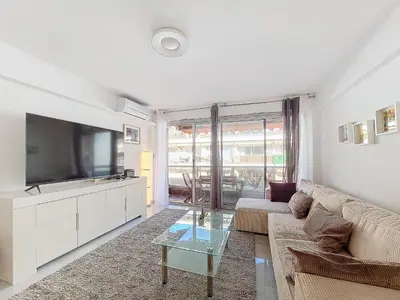 a living room with a couch and a flat screen tv at Nestor&Jeeves - CLEA - Terrasse - Central in Nice