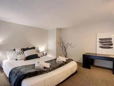 a bedroom with a large bed and a desk at Nestor&Jeeves - VOGUE BEACH - Central - Near Beach in Nice