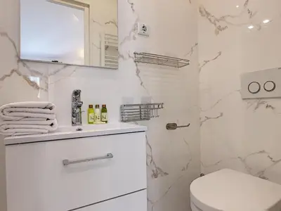 a white bathroom with a toilet and a shower at Nestor&Jeeves - COZY CLOUD - Central - Near Beach in Nice