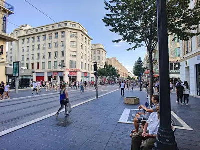 people sitting on a bench on a busy city street at Nestor&Jeeves - COZY CLOUD - Central - Near Beach in Nice