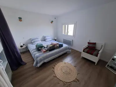 a bedroom with a bed and a window at Appartement spacieux & vue imprenable in Saint-Laurent-du-Var