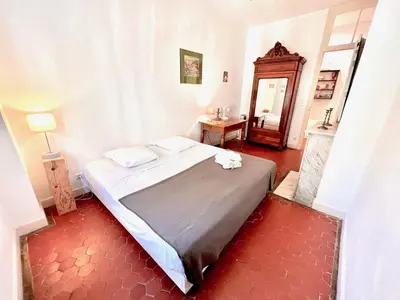 a bedroom with a large bed in a room at E OP Duplex d Antoine Old Port - Old Town in Nice