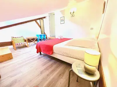 a bedroom with a bed and chairs in a room at E OP Duplex d Antoine Old Port - Old Town in Nice