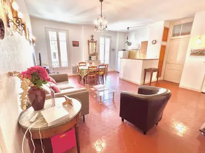 a living room with a couch and a table at E OP Duplex d Antoine Old Port - Old Town in Nice