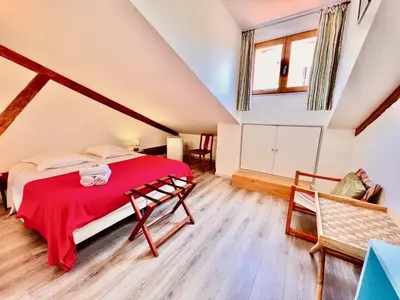a bedroom with a red bed in a attic at E OP Duplex d Antoine Old Port - Old Town in Nice
