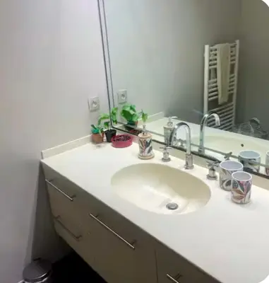 a bathroom with a sink and a mirror at Suite Massena in Nice