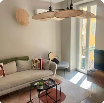 a living room with a couch and a table at Suite Massena in Nice