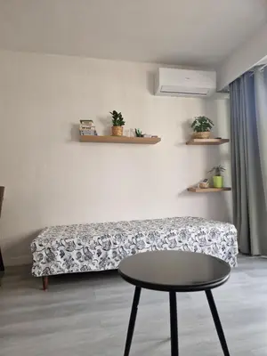 a living room with a couch and a table at Lory's home in Nice