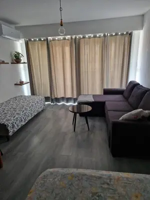 a living room with a couch and a table at Lory's home in Nice