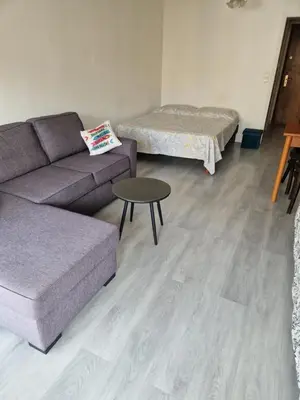 a living room with a couch and a table at Lory's home in Nice