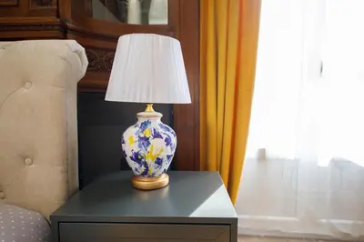 a blue and white vase on a table with a lamp at Villa Monique-Parking free in Nice