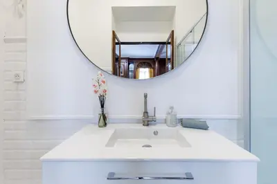 a bathroom with a white sink and a mirror at Villa Monique-Parking free in Nice