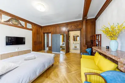 a bedroom with a bed and a yellow couch at Villa Monique-Parking free in Nice