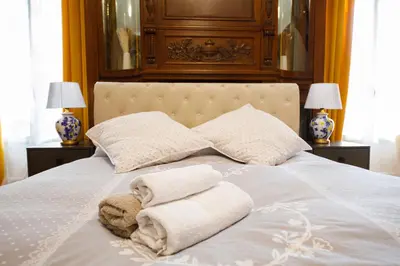 a bed with two towels on it with two lamps at Villa Monique-Parking free in Nice