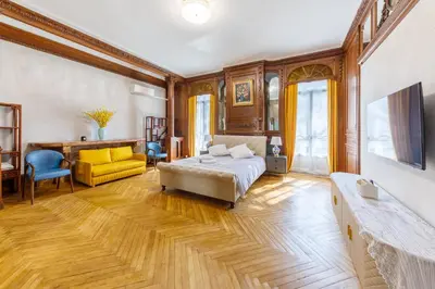 a large bedroom with a bed and a yellow chair at Villa Monique-Parking free in Nice