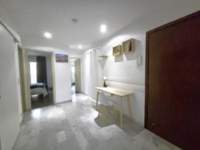 a room with a table and a desk in it at Large T2 50m from the beaches in Nice