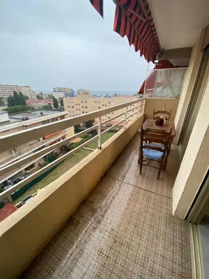 a balcony with a table and a view of a city at T2 Proche plage - Centre cagnes sur mer in Cagnes-sur-Mer