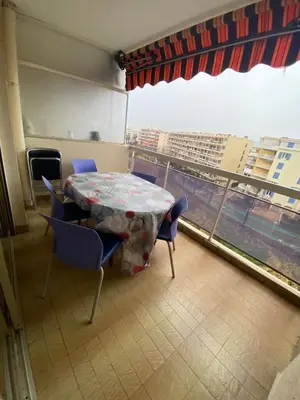 a table and chairs in a room with a window at T2 Proche plage - Centre cagnes sur mer in Cagnes-sur-Mer
