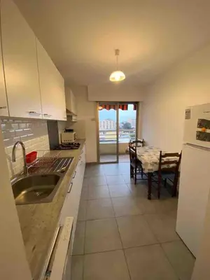 a kitchen with a table and a dining room at T2 Proche plage - Centre cagnes sur mer in Cagnes-sur-Mer