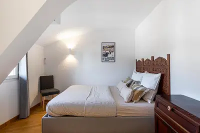 a bedroom with a bed and a chair in it at Charming peaceful haven in the Golden Square, air-conditioned in Nice