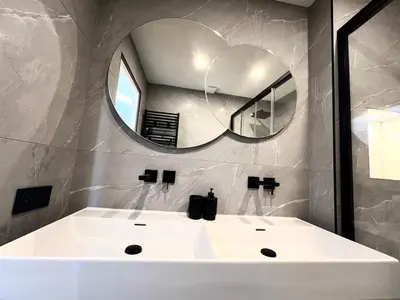 a bathroom with a white sink and a mirror at Charming peaceful haven in the Golden Square, air-conditioned in Nice