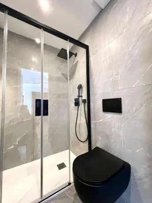 a bathroom with a black toilet and a shower at Charming peaceful haven in the Golden Square, air-conditioned in Nice