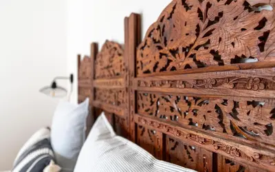 a wooden headboard of a bed in a room at Charming peaceful haven in the Golden Square, air-conditioned in Nice