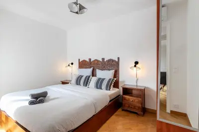 a bedroom with a bed and a mirror at Charming peaceful haven in the Golden Square, air-conditioned in Nice