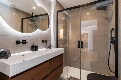 a bathroom with a sink and a glass shower at Charming peaceful haven in the Golden Square, air-conditioned in Nice