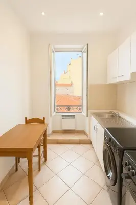 a kitchen with a table and a window at Grand studio dans le centre ville de Nice in Nice