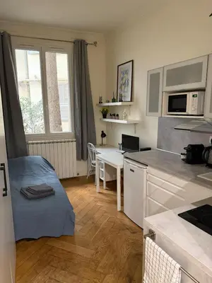 a small kitchen with a desk and a microwave at Hypercentre Studio in Nice