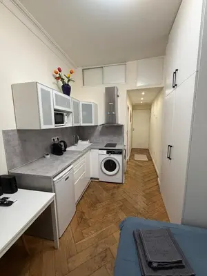 a desk in a kitchen with a table and a chair at Hypercentre Studio in Nice
