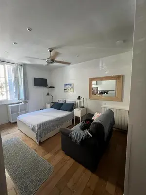 a bedroom with a bed and a couch at Coquette studio YourHostelper in Nice