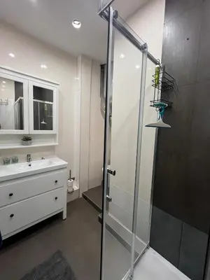 a bathroom with a glass shower and a sink at Coquette studio YourHostelper in Nice