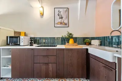 a kitchen with wooden cabinets and a sink at Nice Renting - CENTRALE - Authentic Loft Old Nice Rooftop View & Charm in Nice